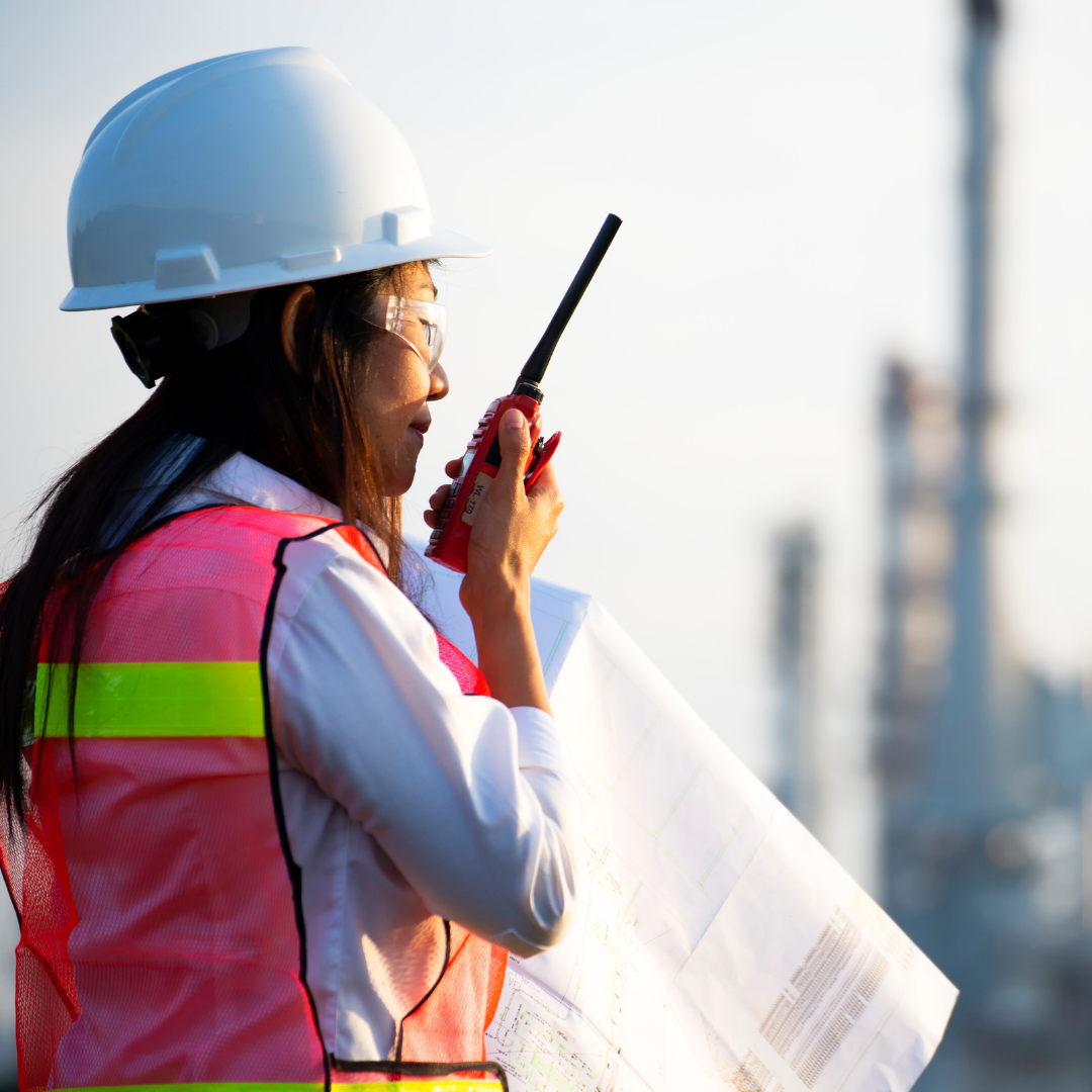 Woman leader in a construction environment reflecting on leadership lessons learned through real-world execution, resilience, and accountability.